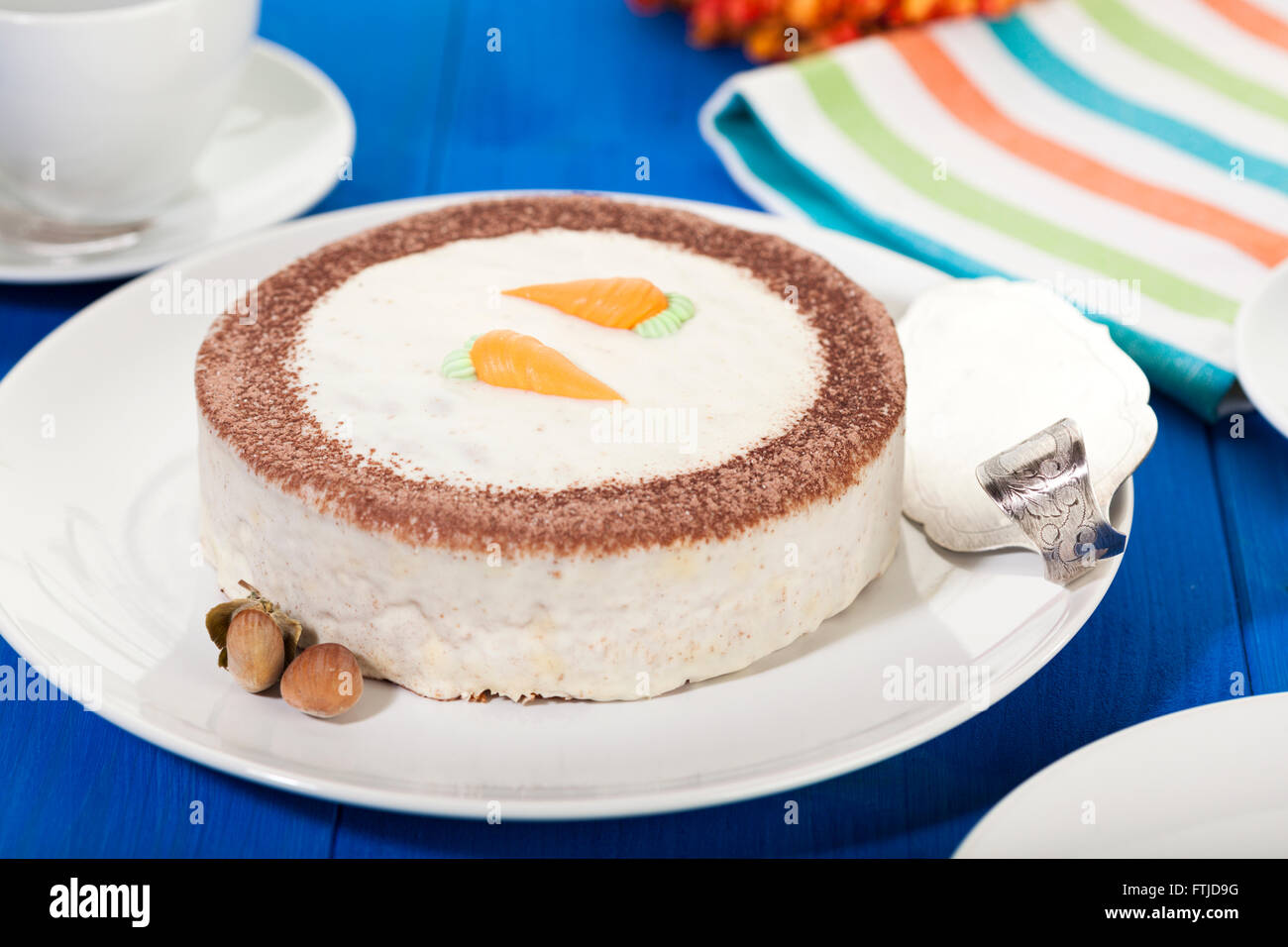Whole Carrot Cake on coffee table Stock Photo