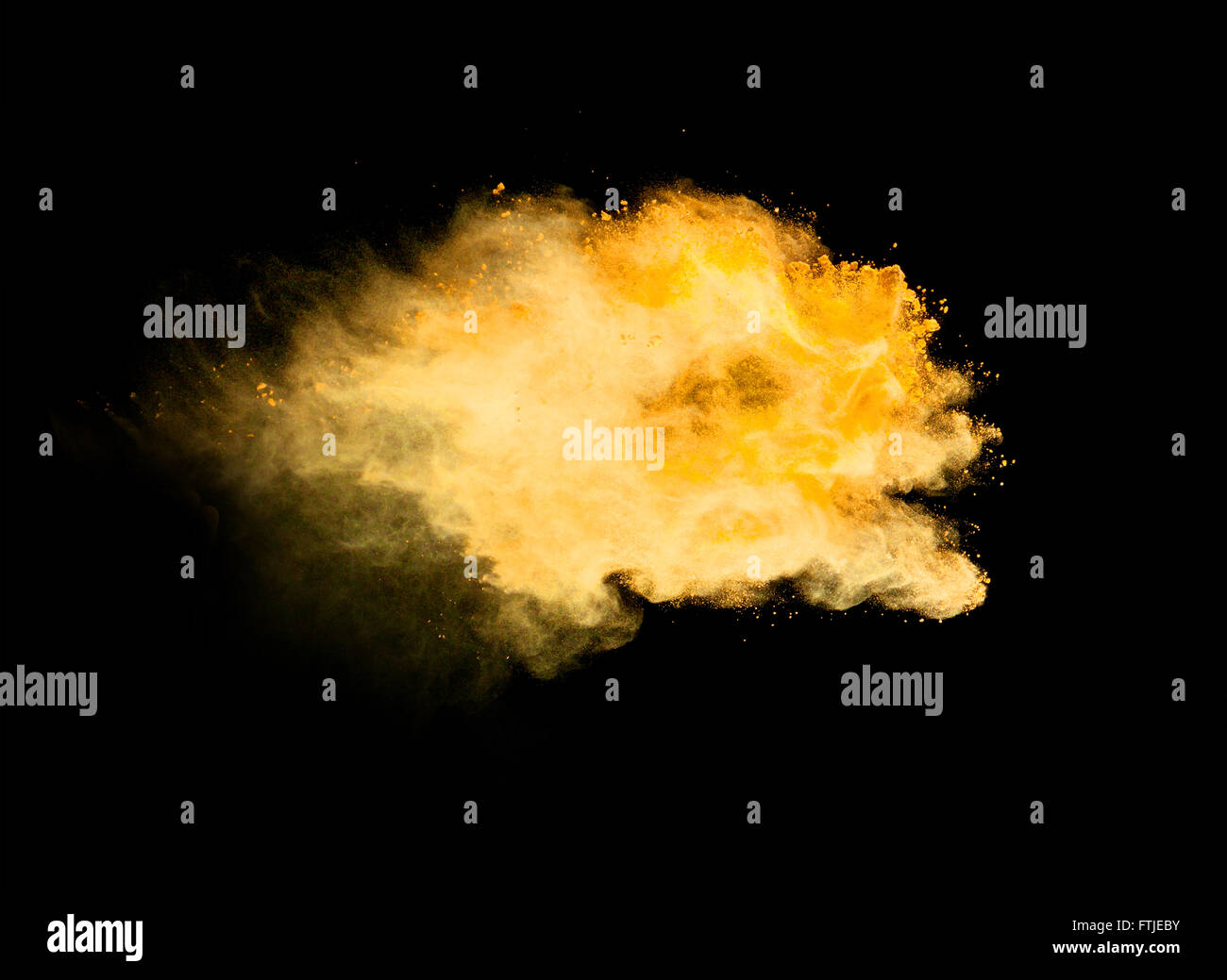 Explosion of yellow powder on black background Stock Photo Alamy