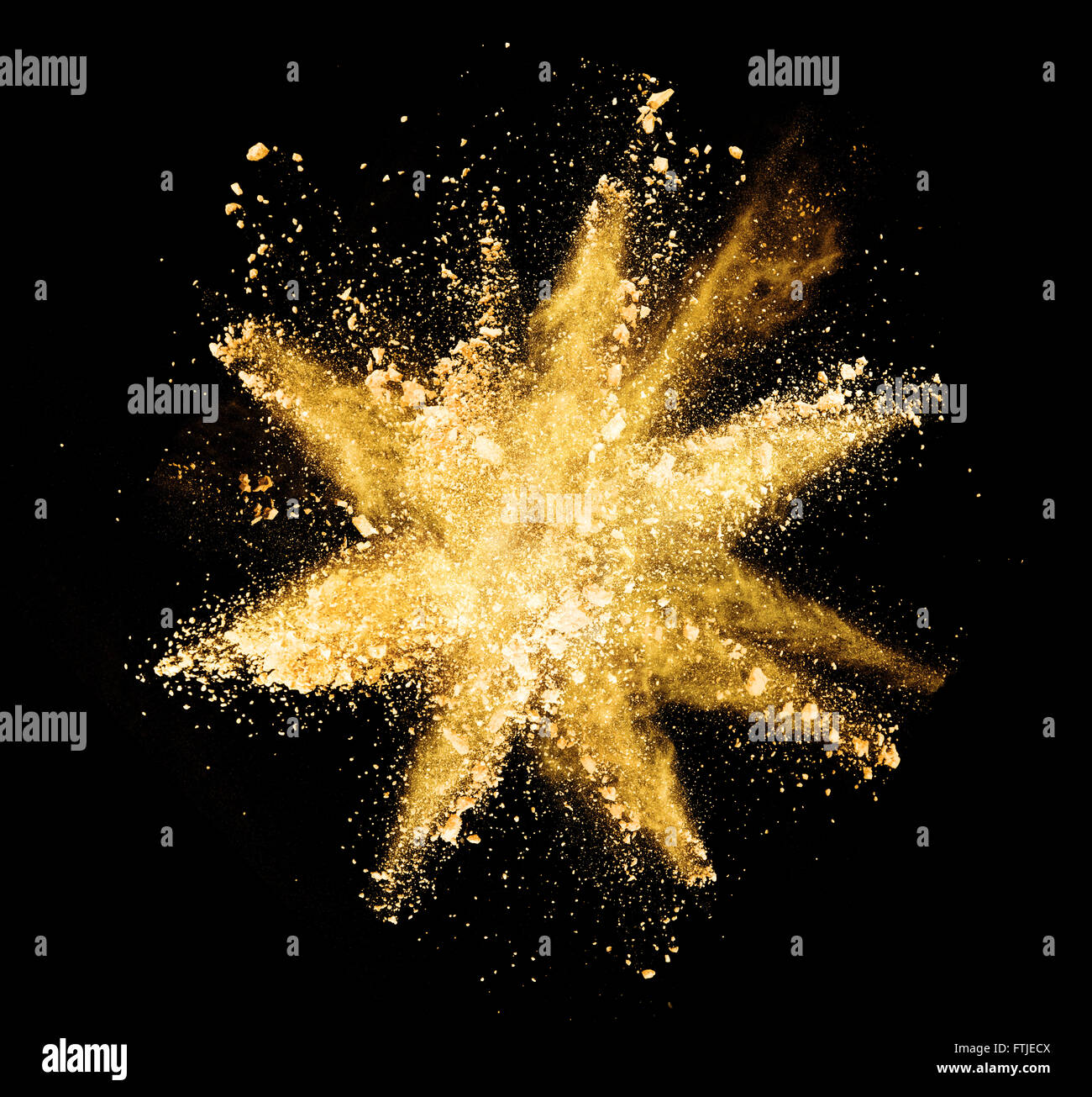 Explosion of yellow powder on black background Stock Photo Alamy