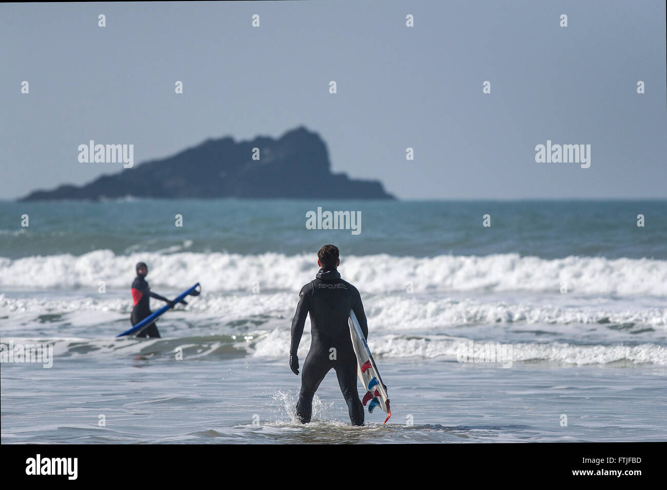 Surfers at Fistral Beach in Newquay, Cornwall. UK. Stock Photo