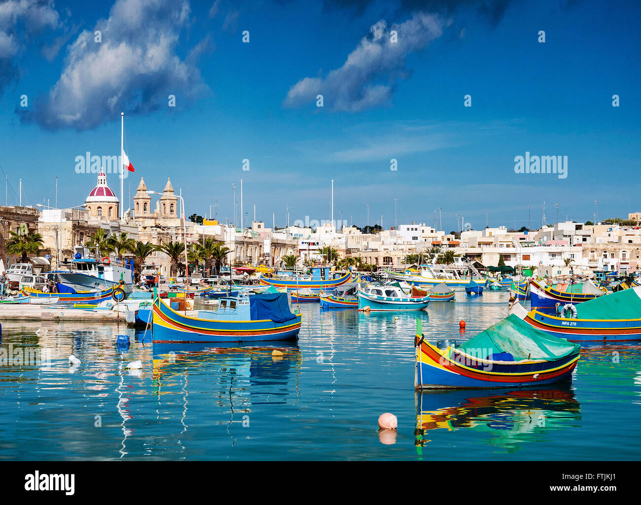 marsaxlokk harbour and traditional mediterranean fishing boats in malta island Stock Photo