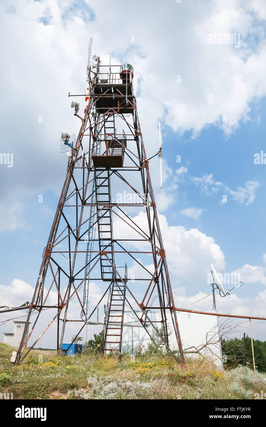 Telecommunication radio tower with different transmitters and receivers devices Stock Photo
