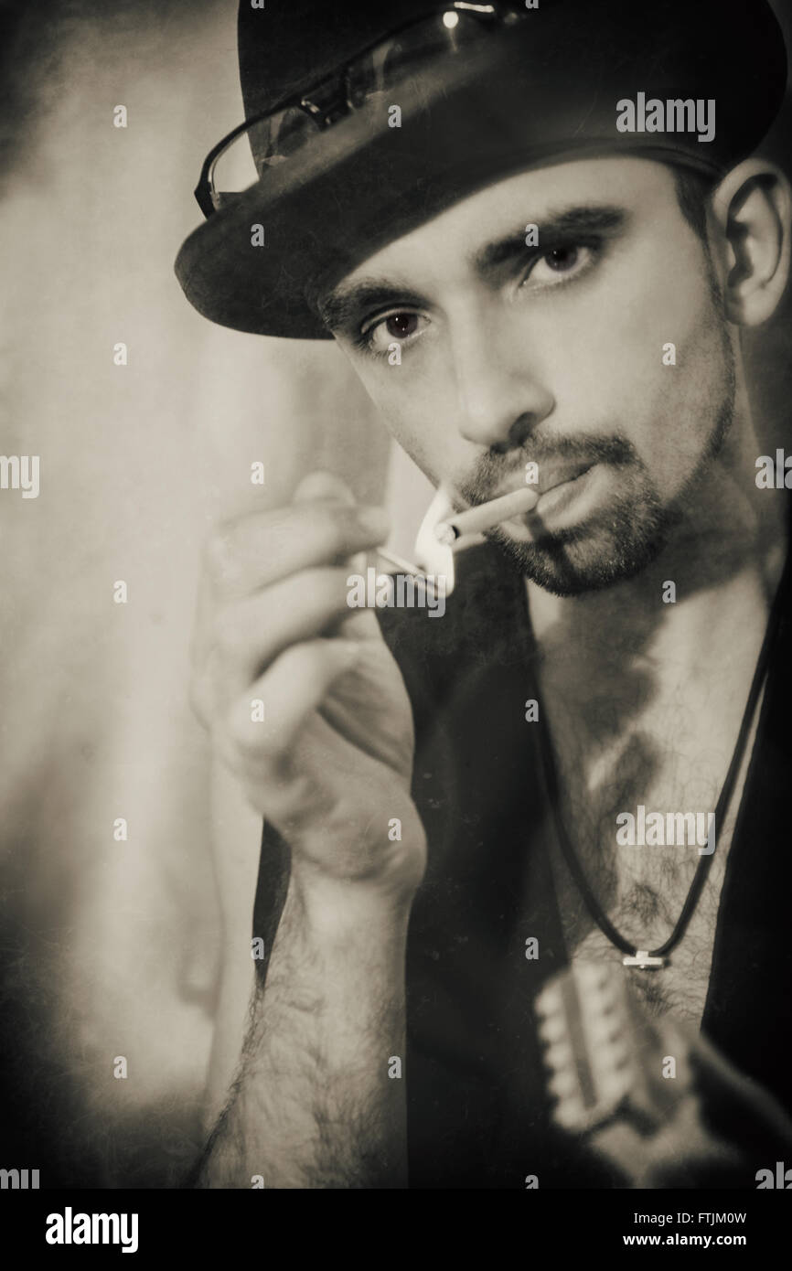 Portrait of  handsome young man wearing hat with cigarette Stock Photo