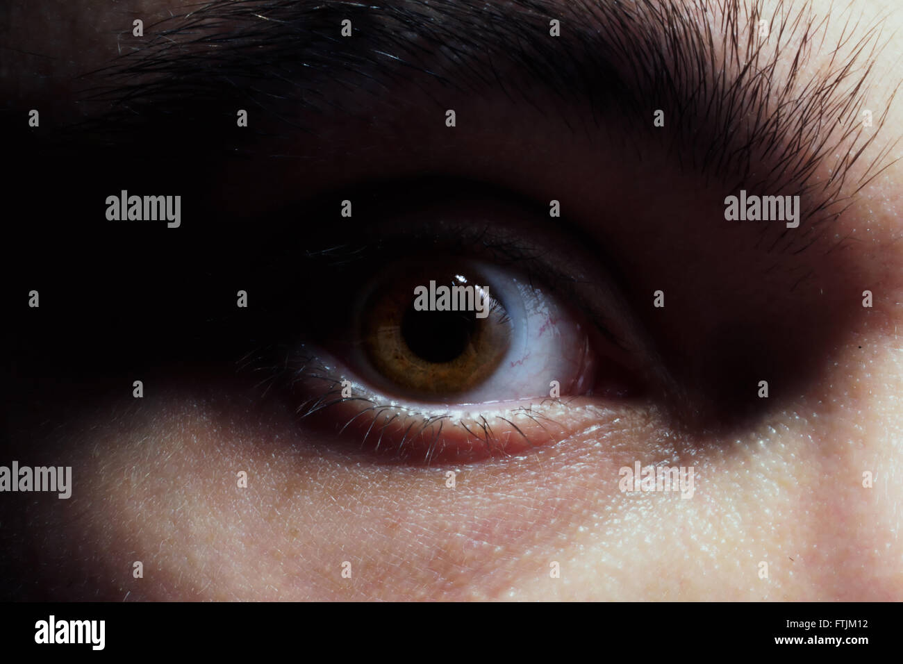 Brown eye of the young man macro Stock Photo - Alamy