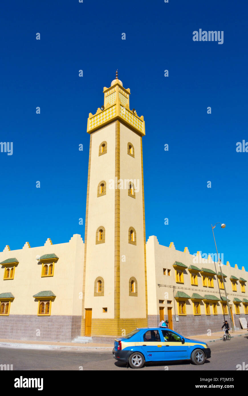 Petit taxi, going past New Mosque, Boulevard Mohammed V, Tan Tan, southern Morocco, northern Africa Stock Photo