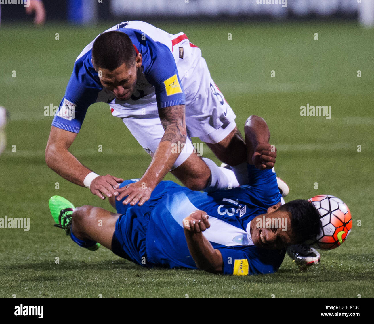 Ohio, USA. 29th March, 2016. USA forward Clint Dempsey (white) trips over Guatemala defender Carlos Castrillo (blue) in a World Cup Qualifying Match. Columbus, Ohio, USA Credit:  Brent Clark/Alamy Live News Stock Photo