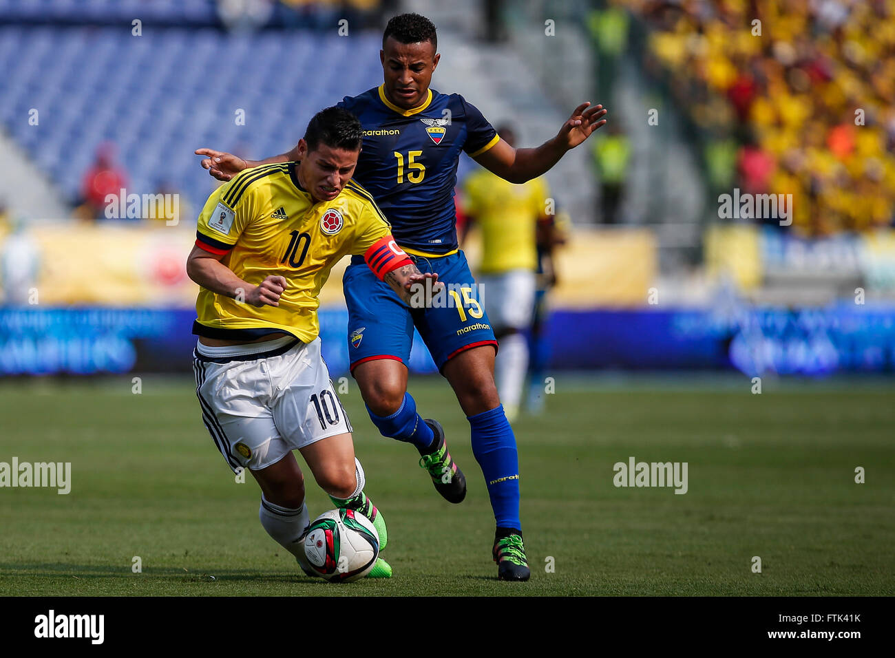 Barranquilla, Colombia. 29th Mar, 2016. Colombia's James Rodriguez (L) vies with Ecuador's Pedro Quinonez during their qualifying match for 2018 Russia World Cup at Metropolitano Roberto Melendez Stadium in Barranquilla, Colombia, on March 29, 2016. Colombia won 3-1. © Mauricio Alvarado/COLPRENSA/Xinhua/Alamy Live News Stock Photo