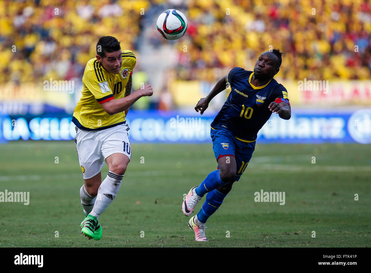 Barranquilla, Colombia. 29th Mar, 2016. Colombia's James Rodriguez (L) vies with Ecuador's Walter Ayovi during their qualifying match for 2018 Russia World Cup at Metropolitano Roberto Melendez Stadium in Barranquilla, Colombia, on March 29, 2016. Colombia won 3-1. © Mauricio Alvarado/COLPRENSA/Xinhua/Alamy Live News Stock Photo
