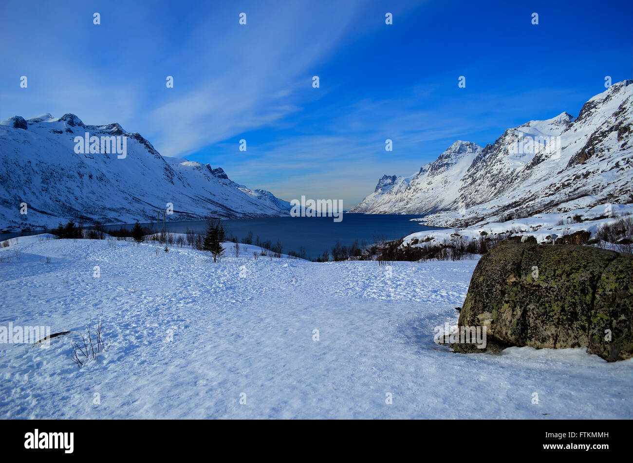 snowy mountain with sunshine blue sky and fjord landscape Stock Photo ...