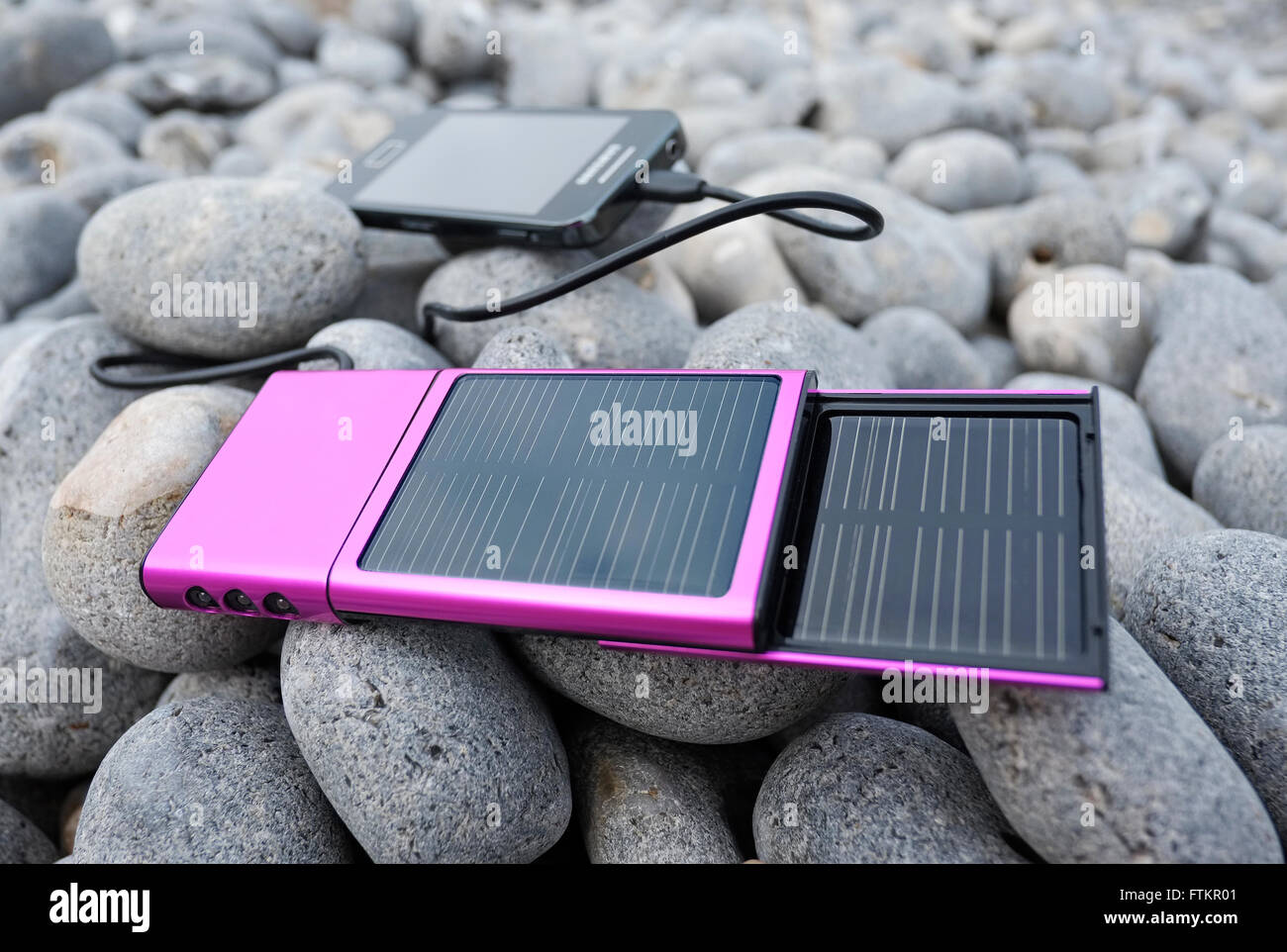 mobile phone solar powered battery charger Stock Photo