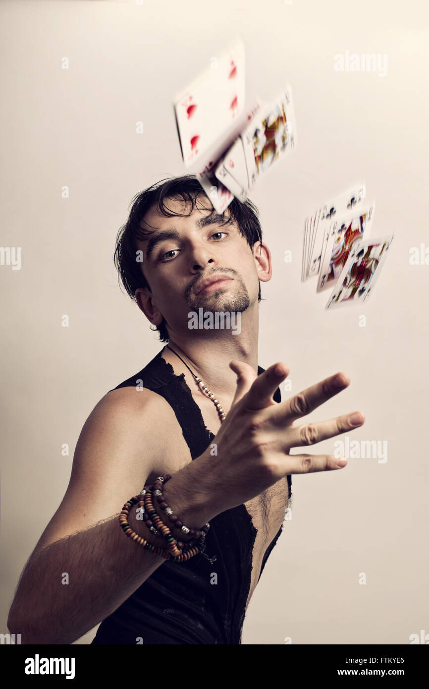 Portrait of young man throws playing cards Stock Photo Alamy