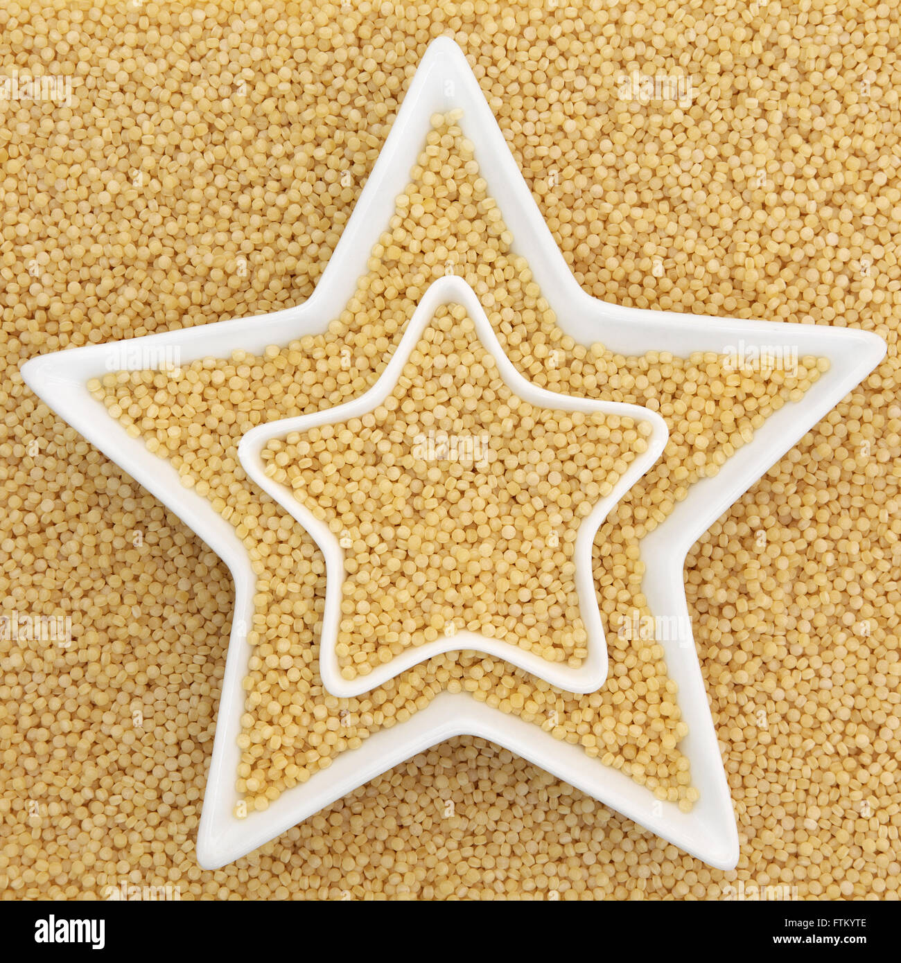 Pearl couscous health food in star shaped bowls forming an abstract background. Stock Photo