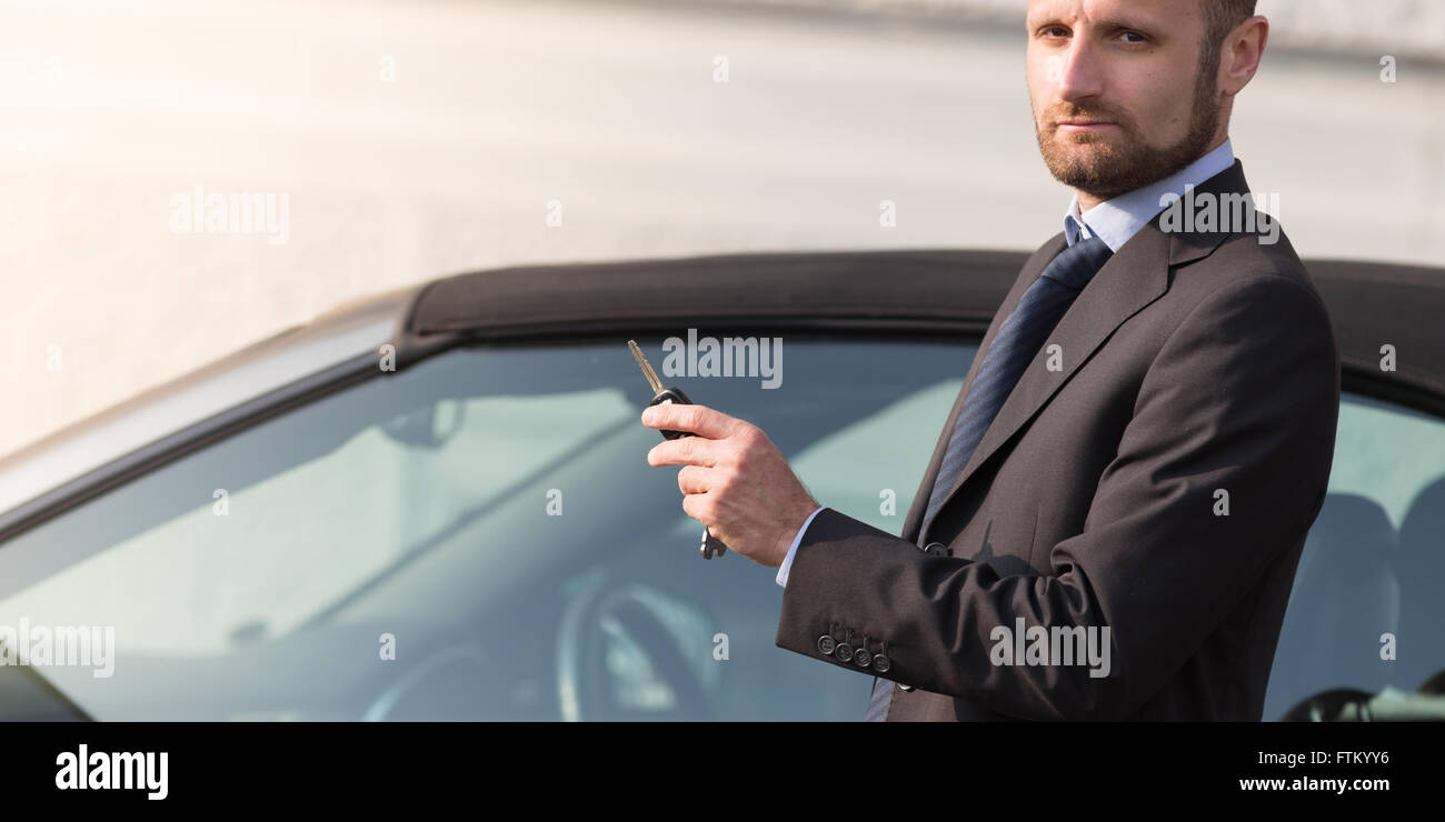 Businessman with his luxury car Stock Photo