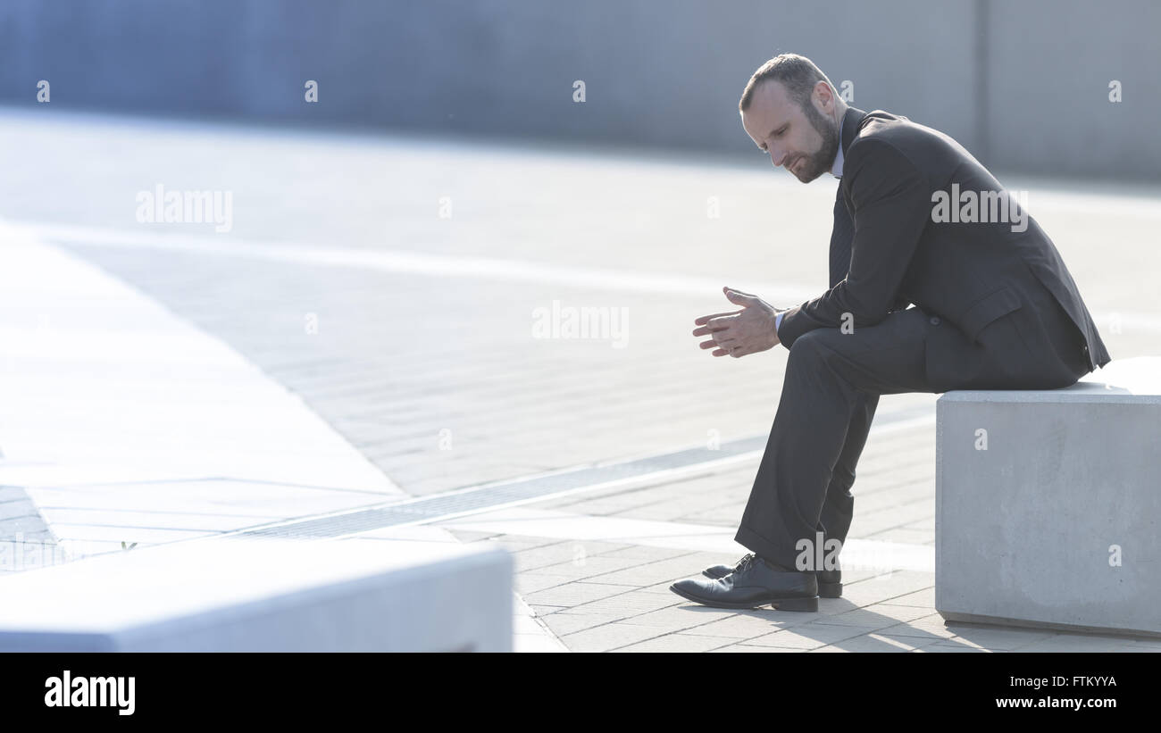 Unhappy and depressed businessman outdoor in the city Stock Photo - Alamy