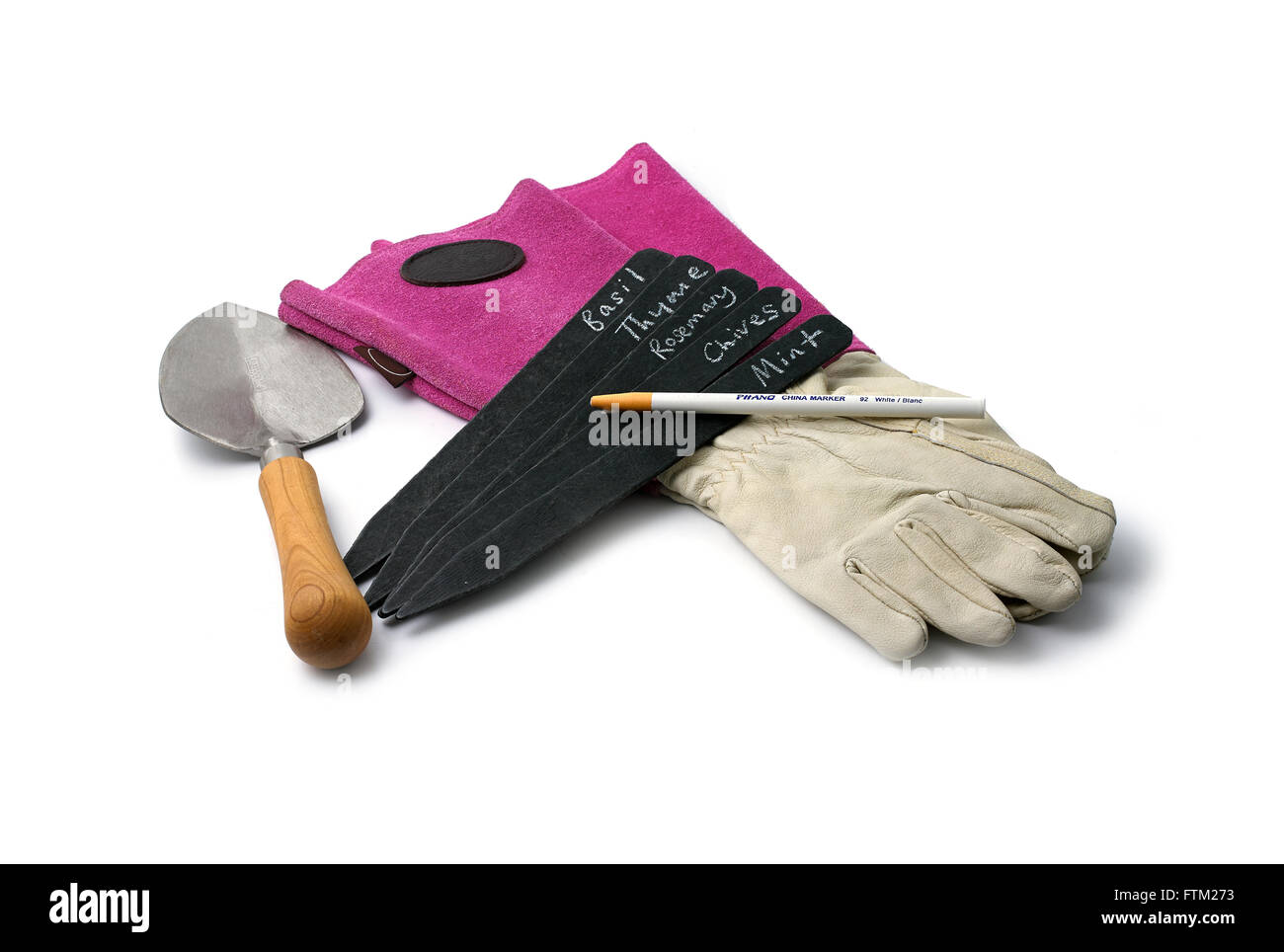 Gardening gloves, tags, pencil and trowel Stock Photo