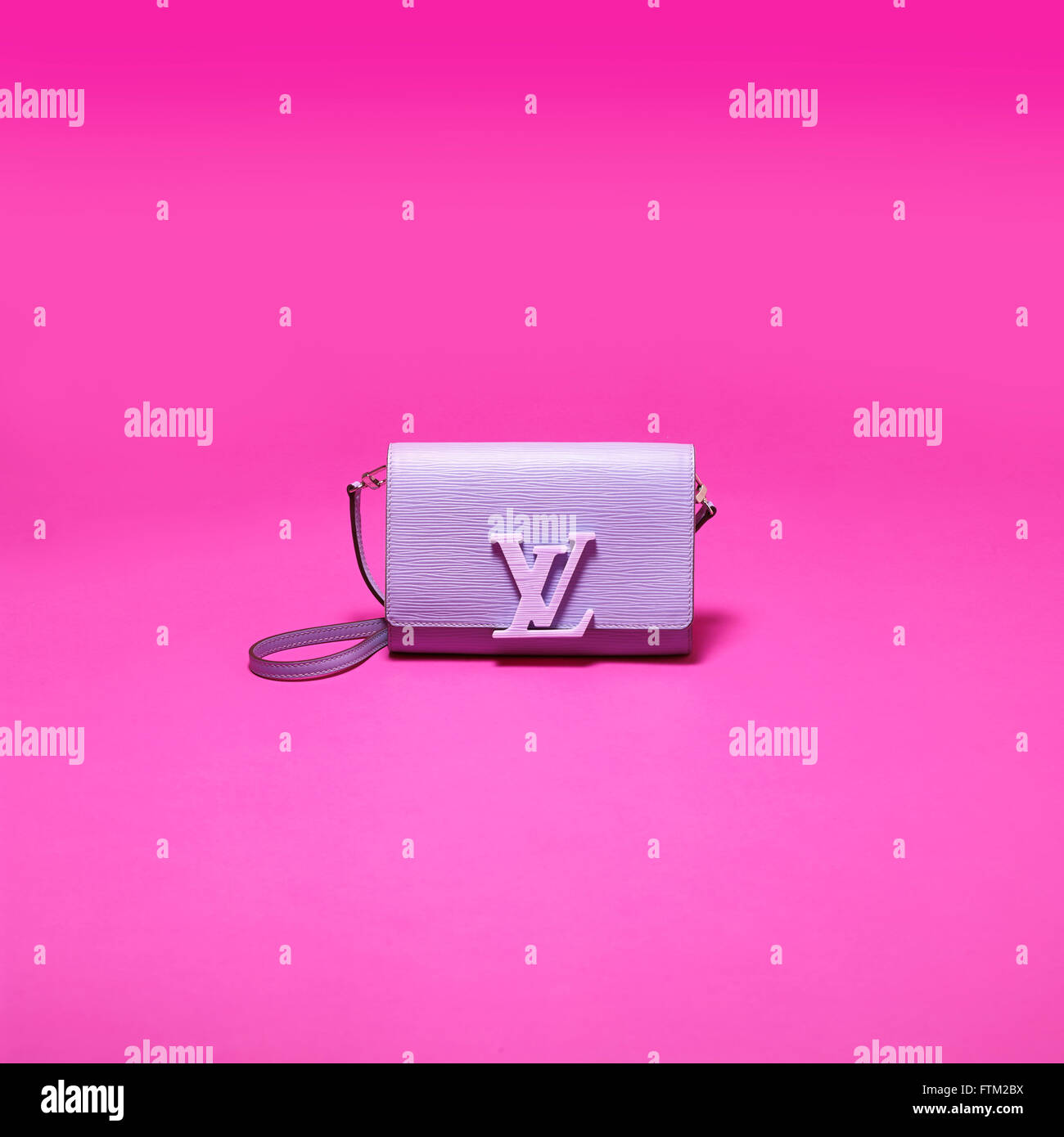 Louis Vuitton handbag on pink background Stock Photo