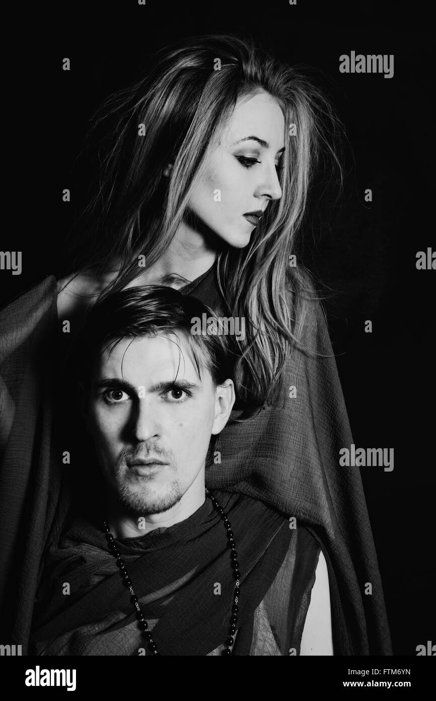 young man and woman on black background Stock Photo - Alamy