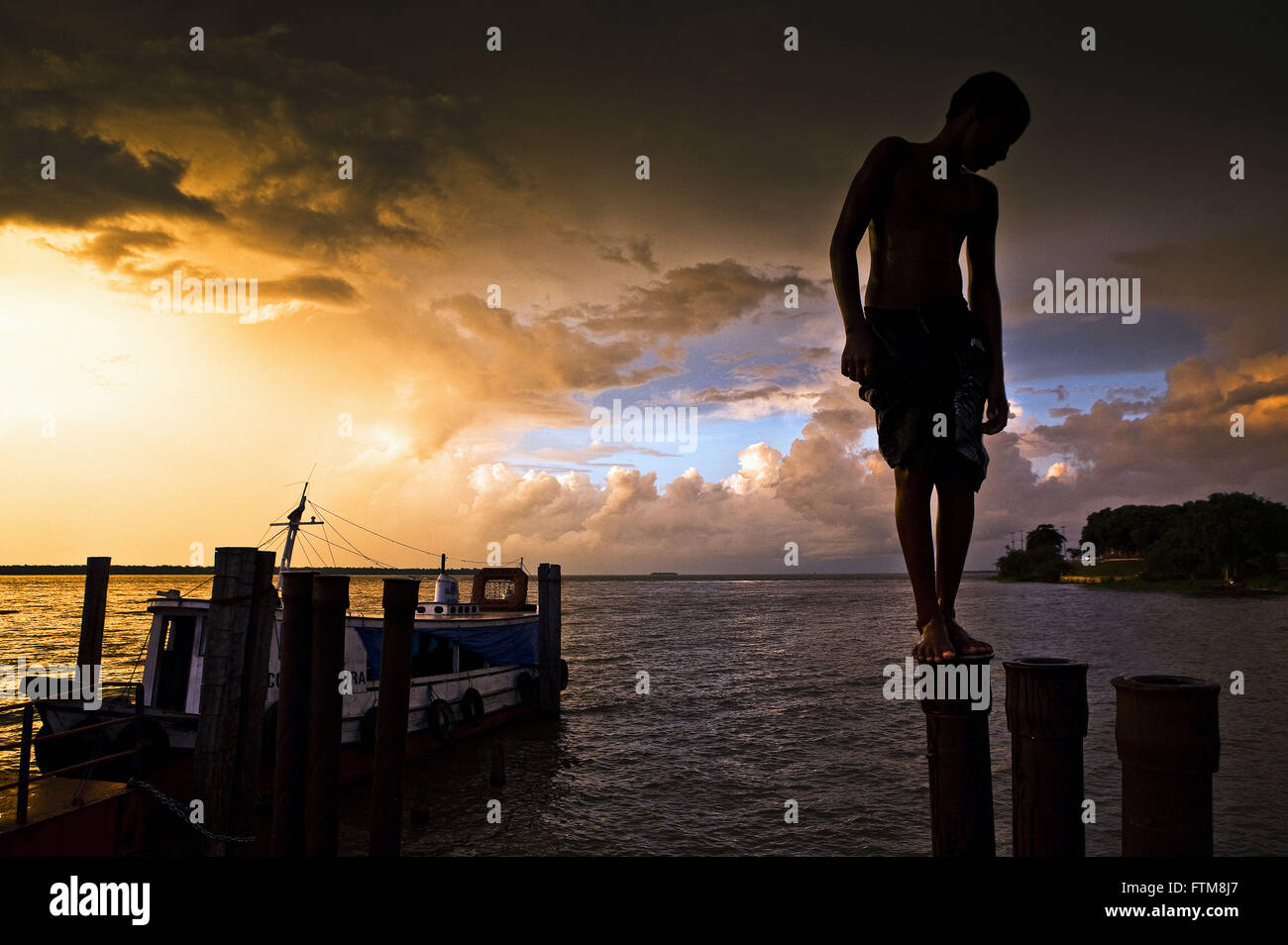 Teenager prepares to swim in the Amazon River District Icoaraci Stock