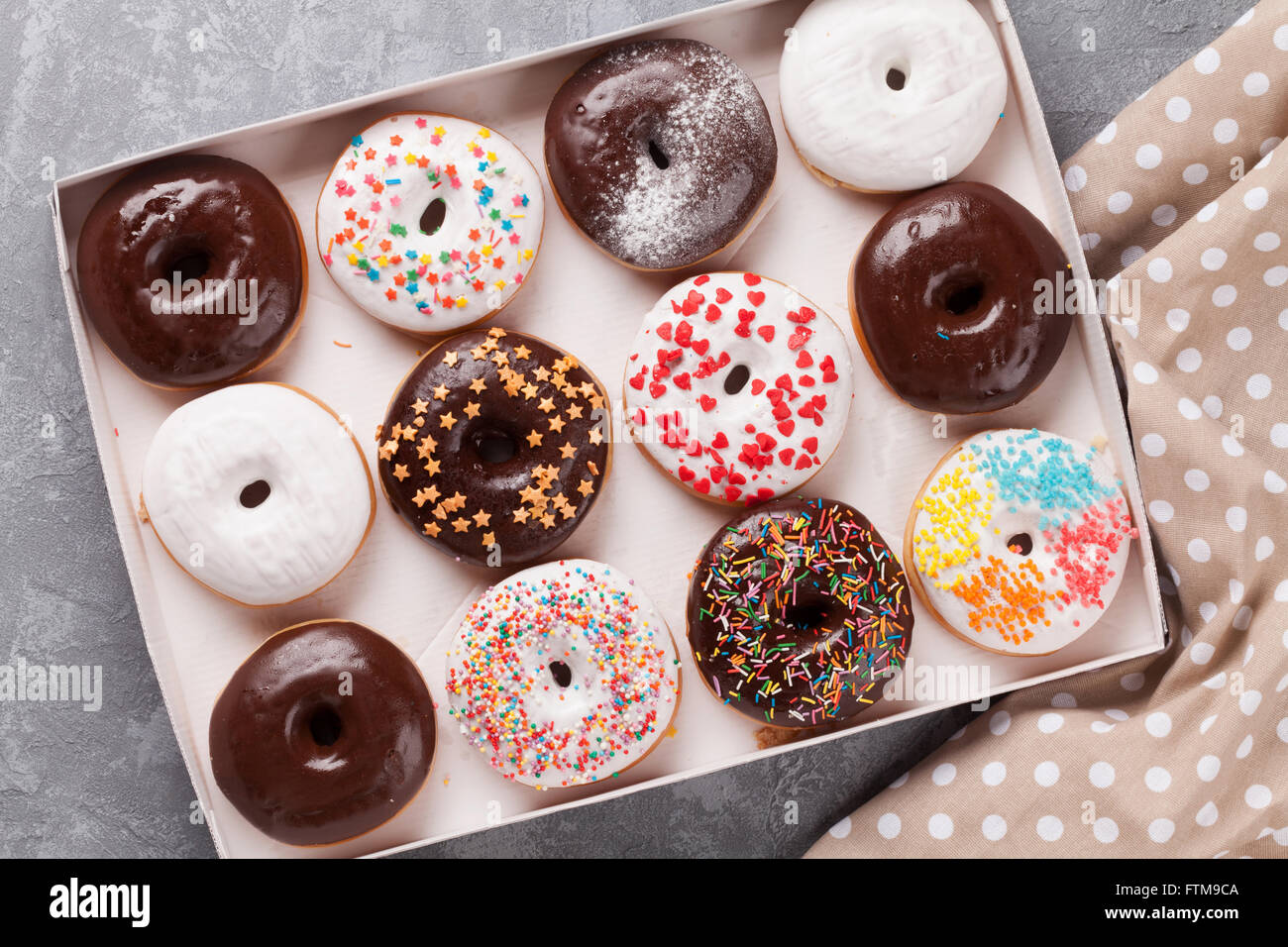 Colorful donuts box on stone table Stock Photo - Alamy