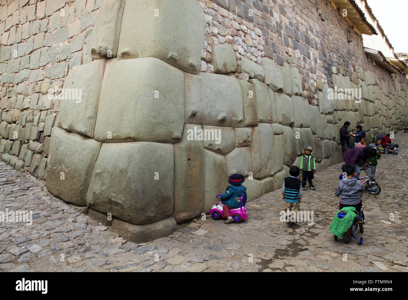 Children in the ruins of the Fortress of Sacsayhuaman - Cusco region of Peru Stock Photo