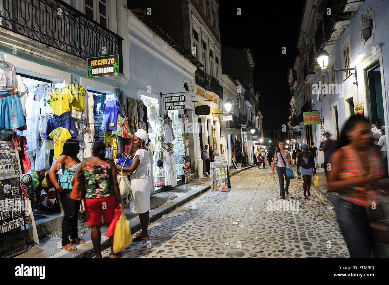Night view of movement of tourists shopping street - stores located in colonial buildings Stock Photo