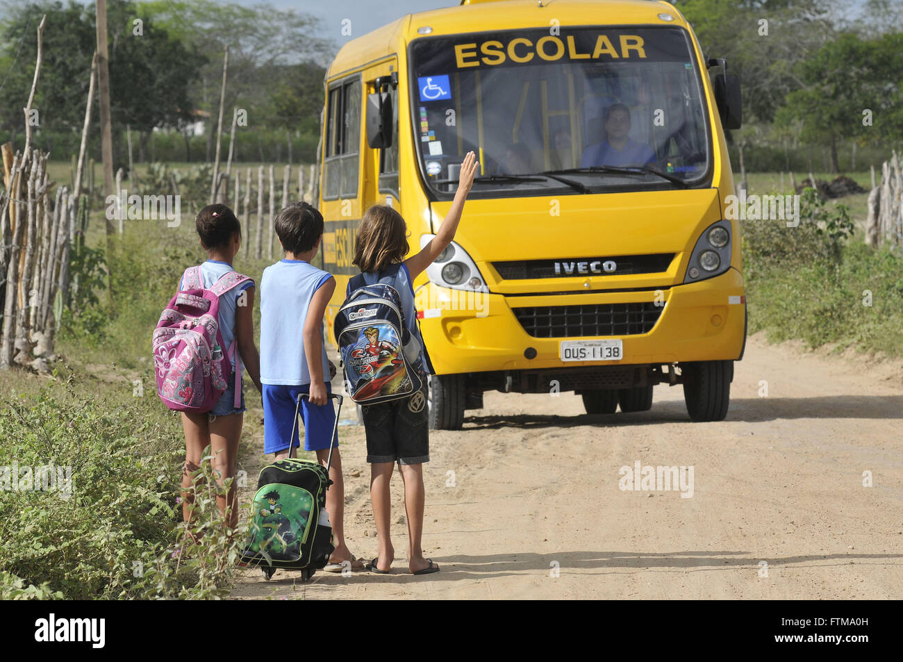 Children waiting for school buses in the village of Umbuzeirinho Stock Photo