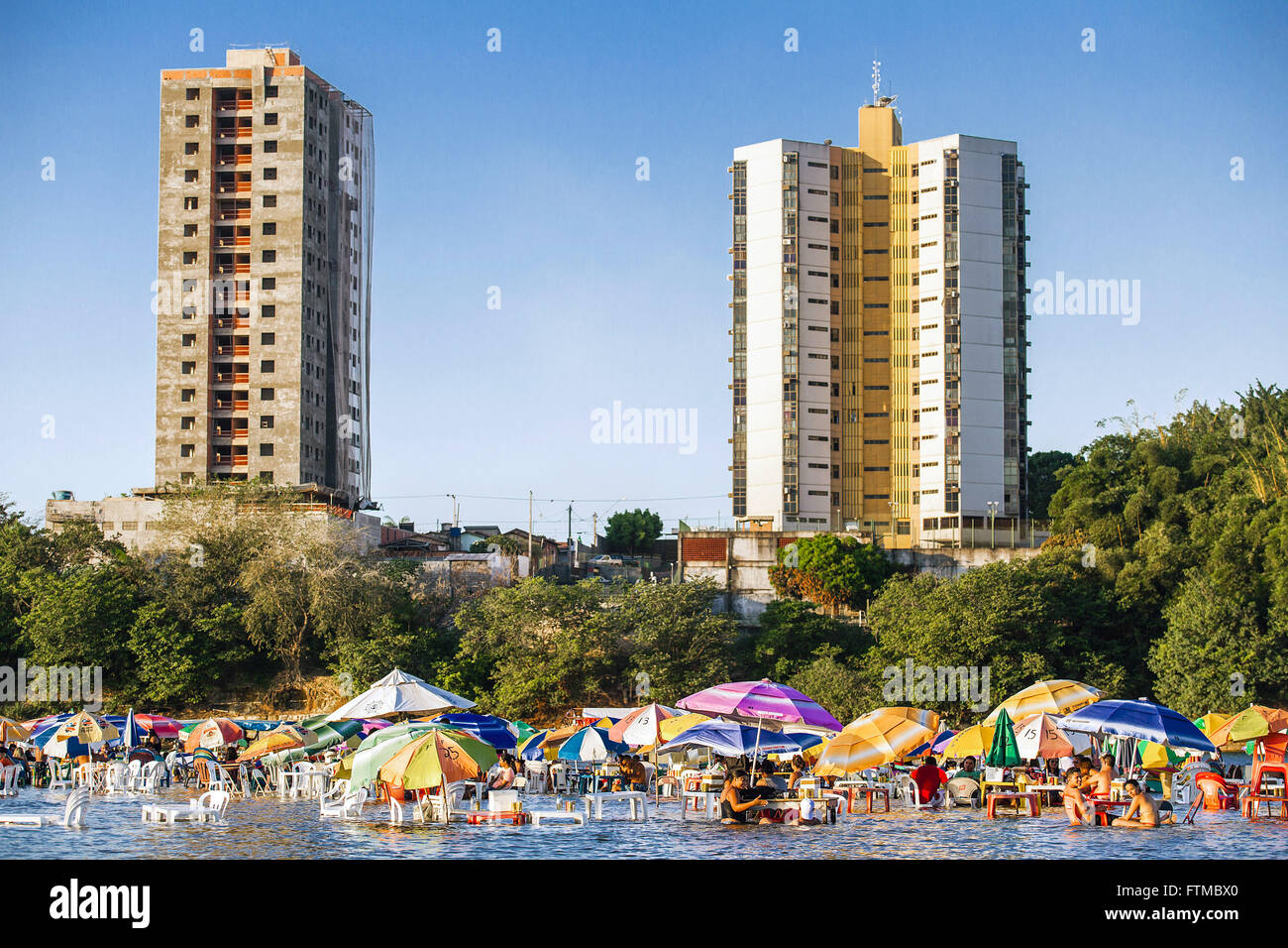 Bathers on the Tocantins River and city in the background Stock Photo