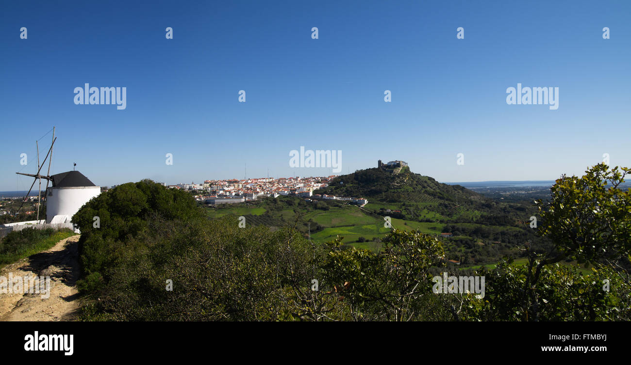 Panorama of wind mill and Palmela under blue sky. Portugal Stock Photo