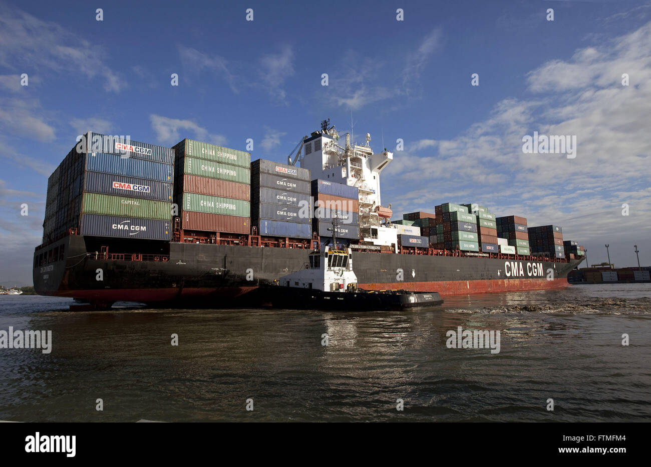 Cargo ship loaded with containers maneuvering in Rio Itajai-Acu - Port of  Navegantes Stock Photo - Alamy