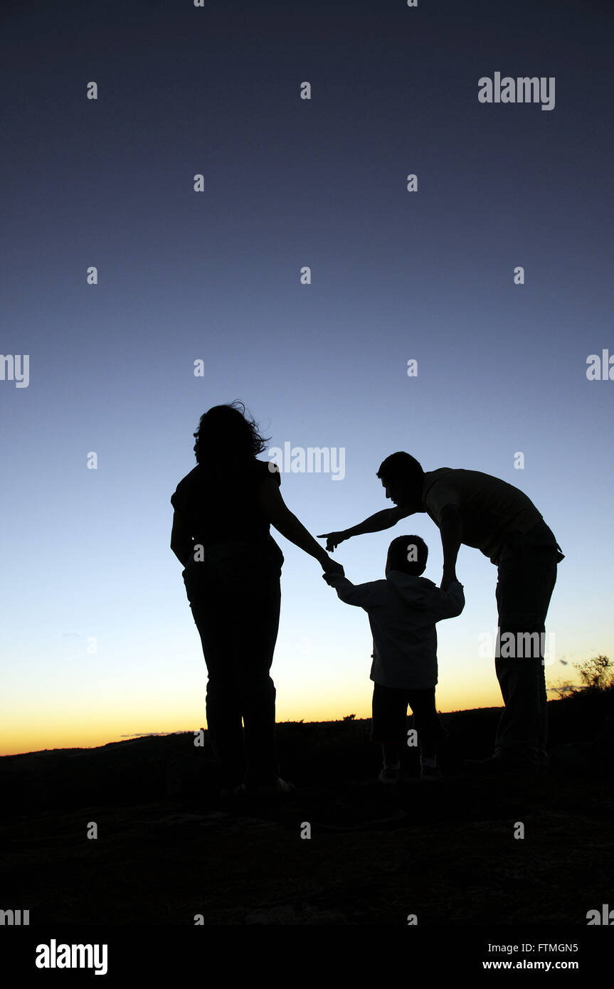 Family watching the sunset in the rural town of Triunfo Stock Photo