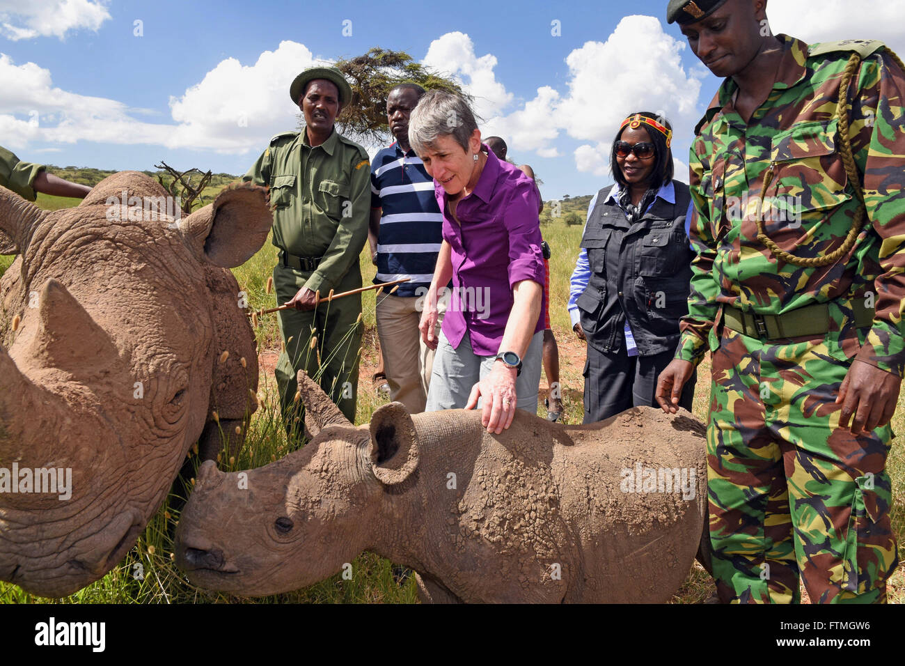 U.S. Secretary of Interior Sally Jewell pets a baby rhino during a visit to the Lewa Wildlife Conservancy in April 15, 2014 in Meru, Kenya. Stock Photo