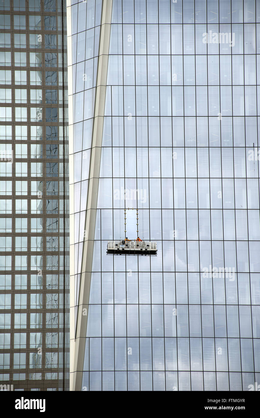 Workers cleaning the window panes of One Tower, building known as