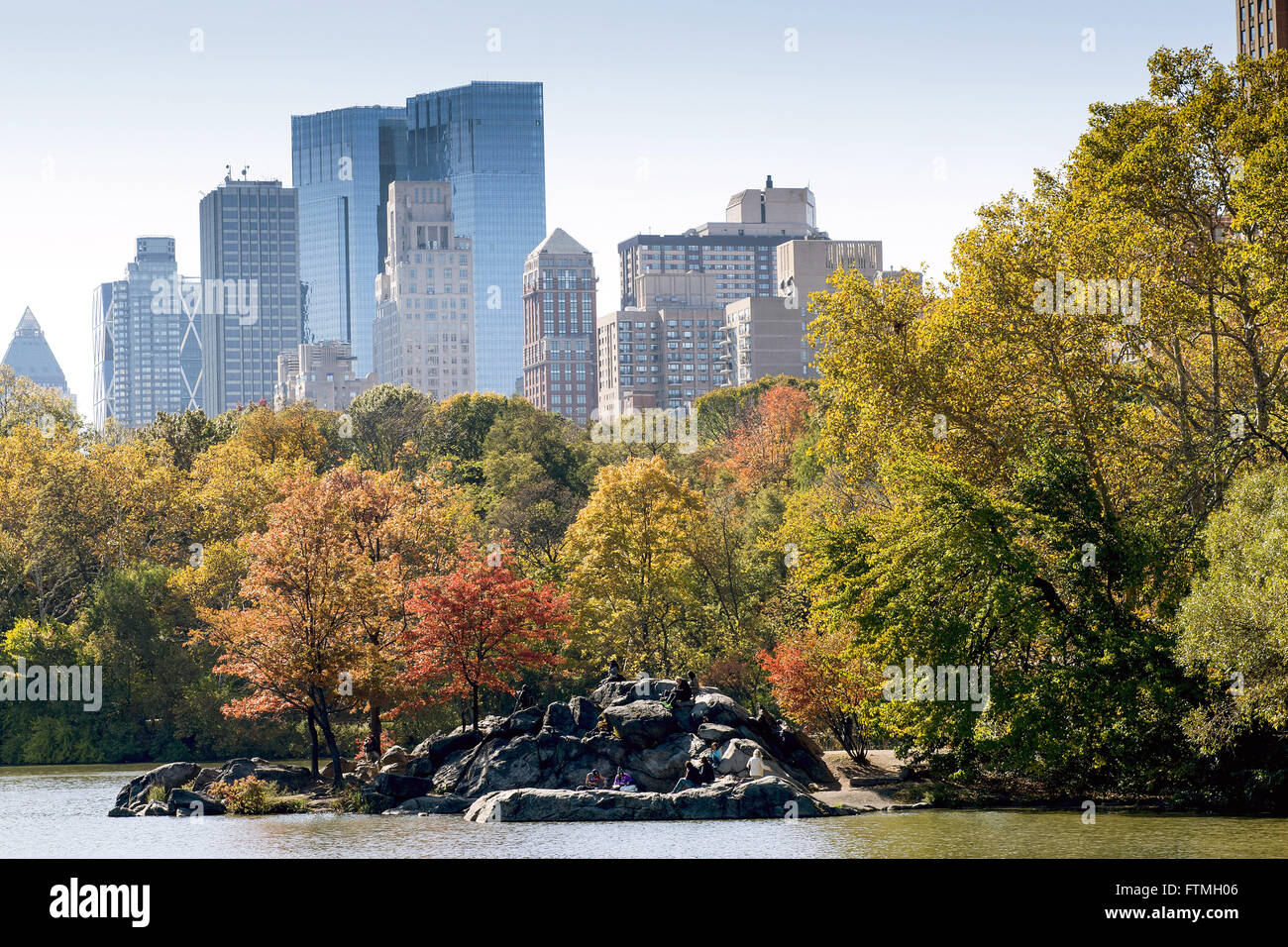 trees in autumn in Central Park with commercial buildings in the background Stock Photo