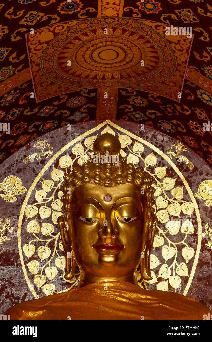 Golden Buddha Face at Wat Chet Yot with buddist ornamentation Stock Photo