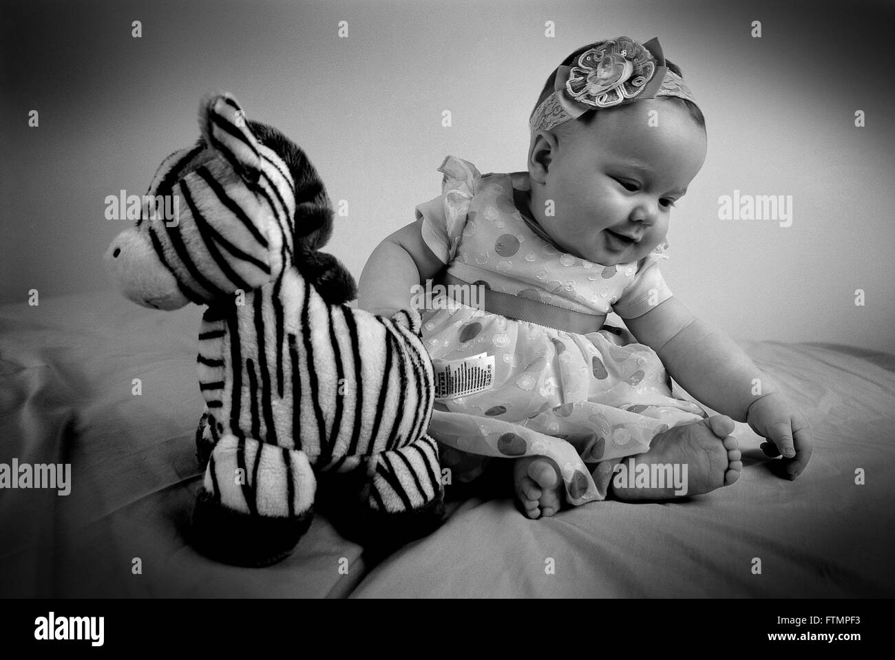 Baby girl and her cuddly toy Stock Photo Alamy