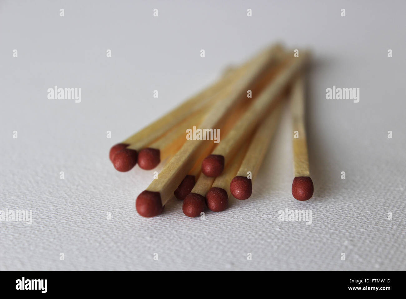 A pile of matches against a white background ready to strike Stock Photo