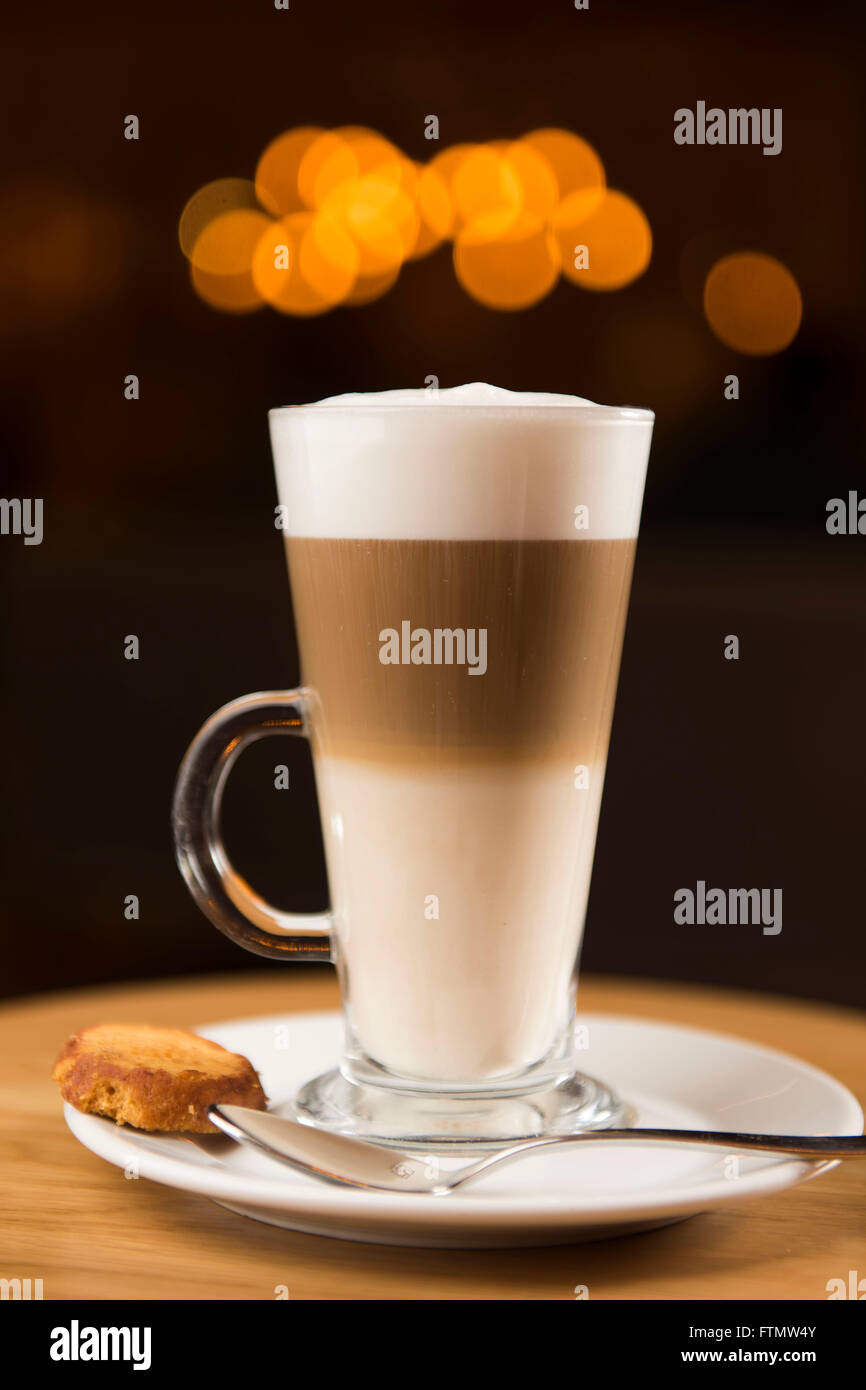 A tall glass off latte coffee in a coffee shop bar. Stock Photo