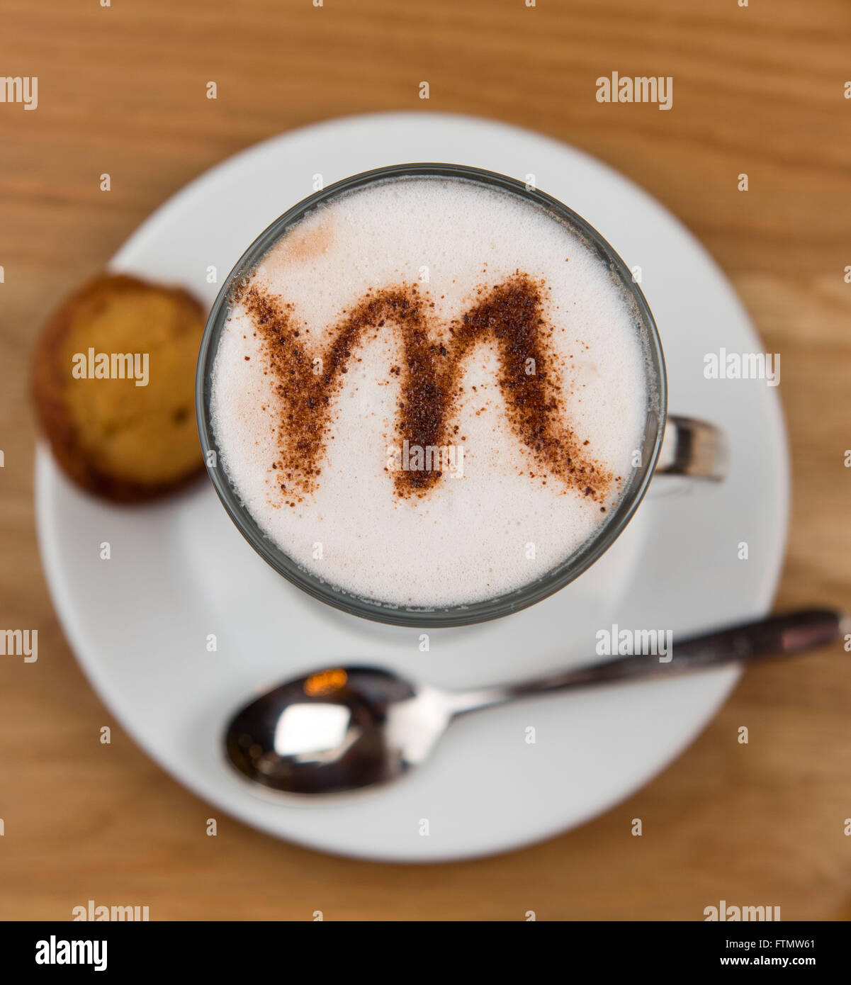 A coffee cappuccino latte with a letter M written into the milk foam Stock Photo Alamy