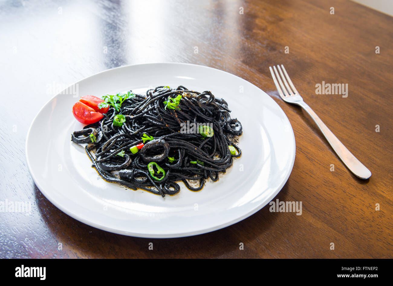 Pasta with squid ink and seafood Stock Photo