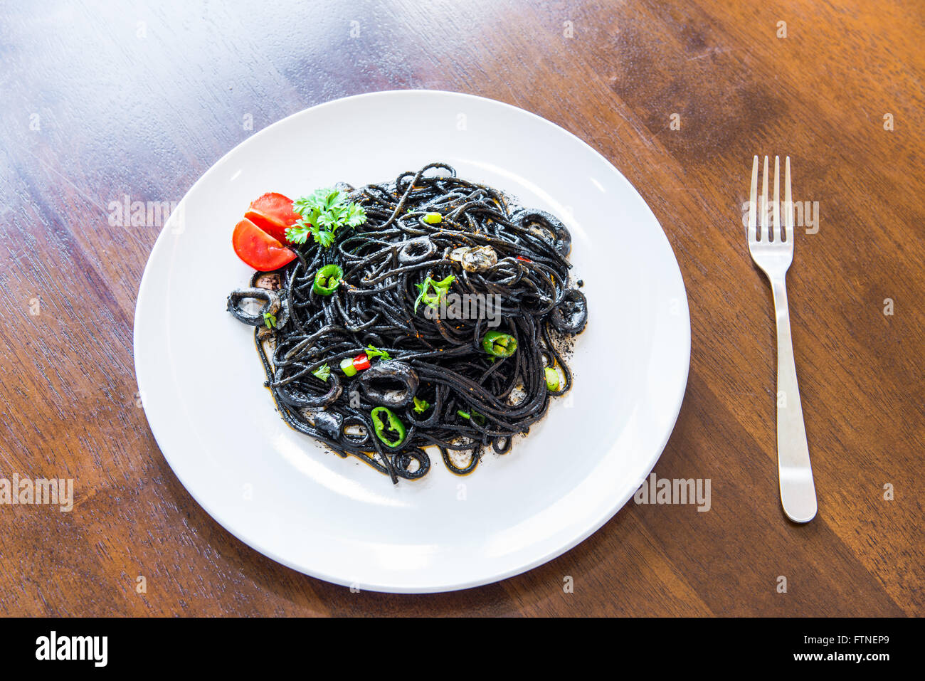Pasta with squid ink and seafood Stock Photo