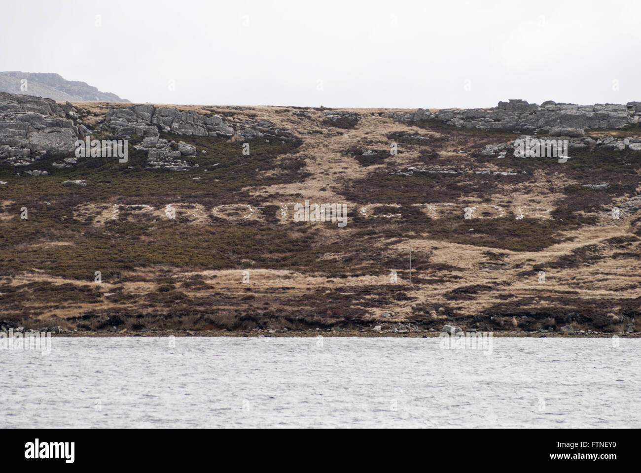 H.M.S. Protector's name written in the rocks on Cortley Hill, Stanley, Falkland Islands Stock Photo