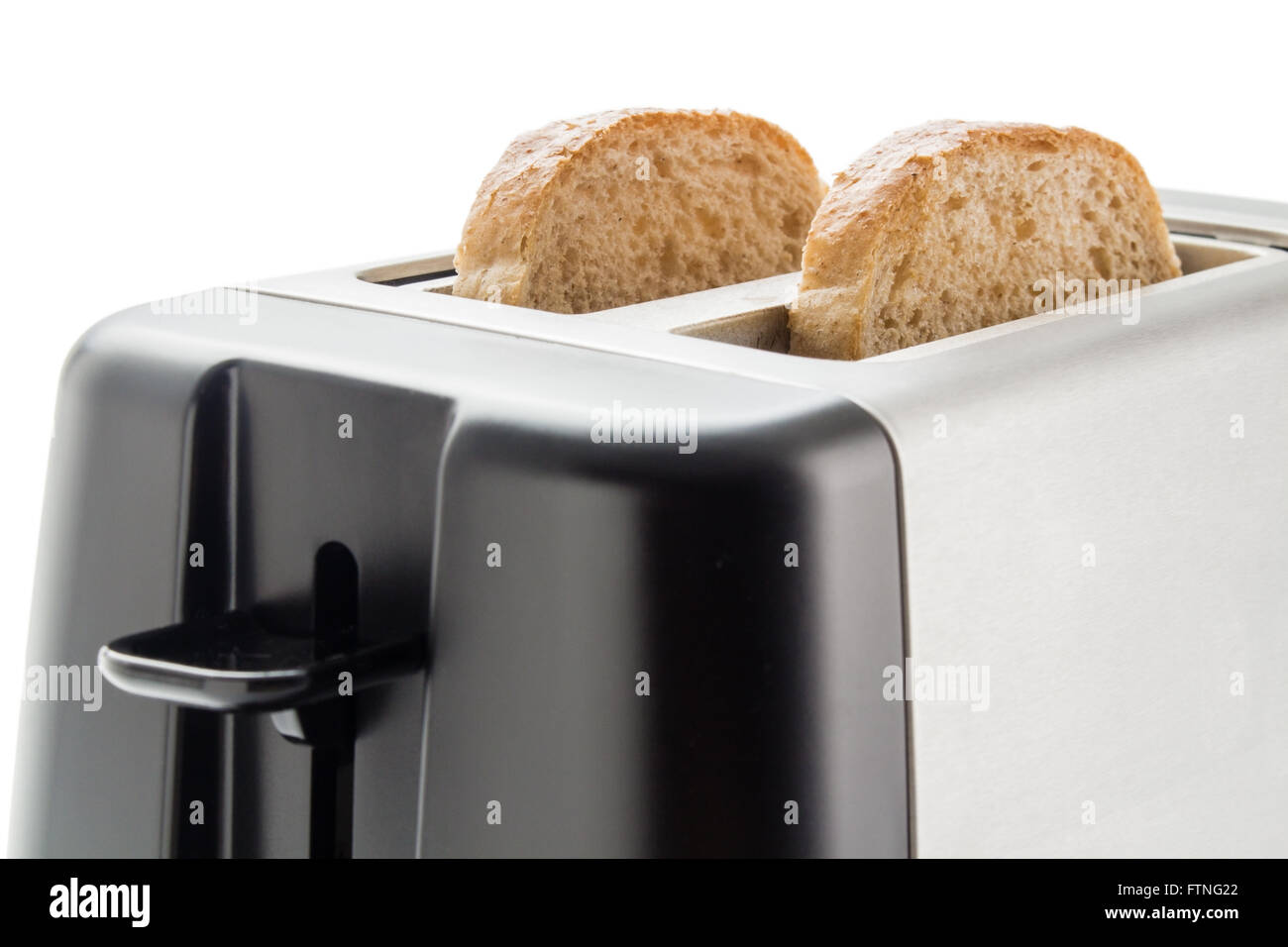 Electric toaster with two wholemeal bread slices close up isolated on