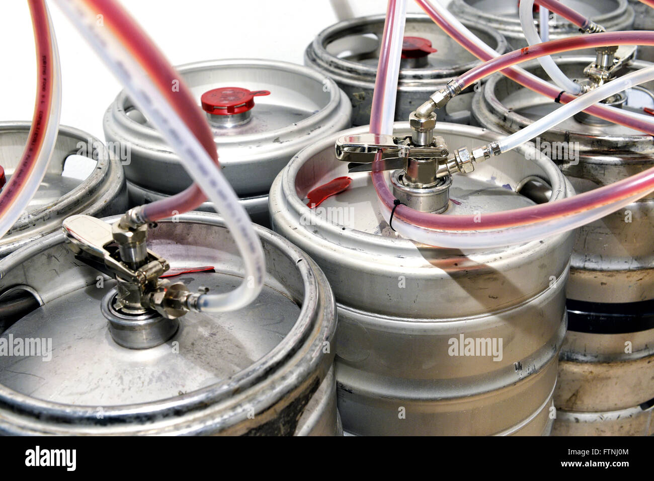 Metal drums filled with draught beer for a tavern or winery with pipes attached to a large cask Stock Photo