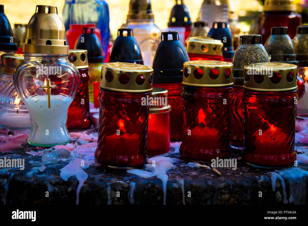 burning candles in lanterns in cemetery Stock Photo Alamy