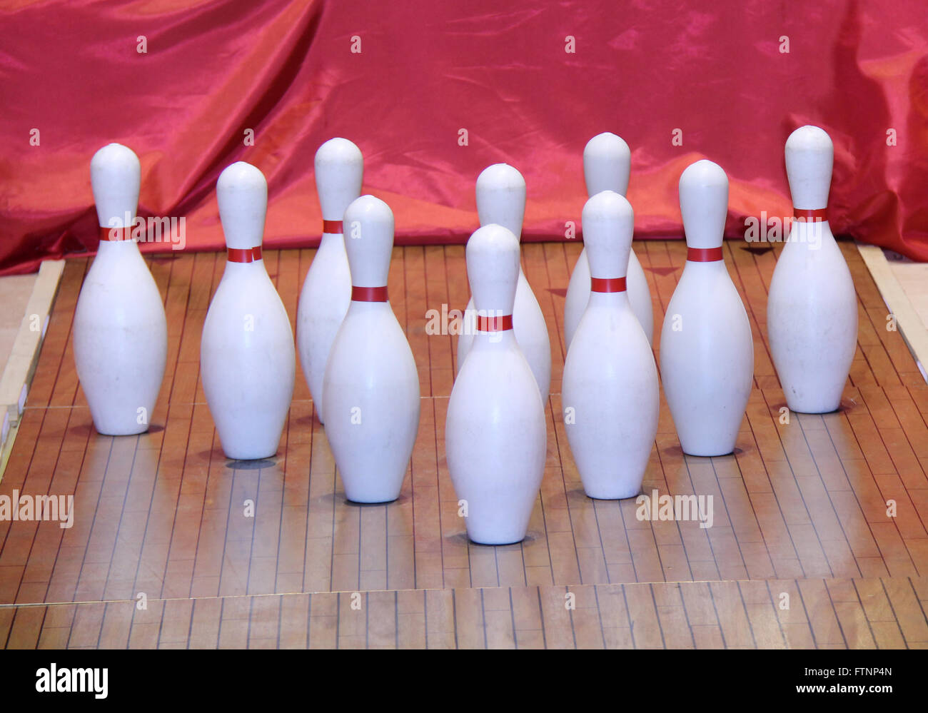 A Set of Tens Pins on a Wooden Bowling Alley. Stock Photo