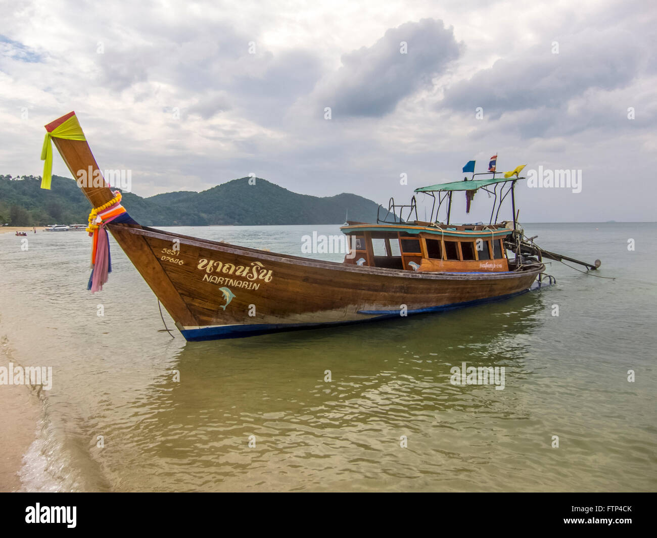 Long tailed boat on the beach on the island of Kho Yao Yai Thailand. Boat used to ferry tourists to nearby islands. Stock Photo