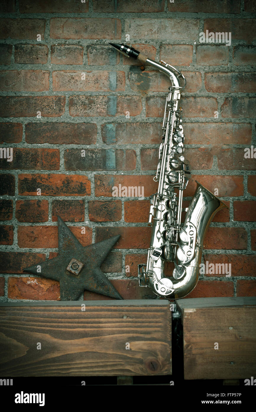 Jazz musical instrument saxophone with grungy street background Stock