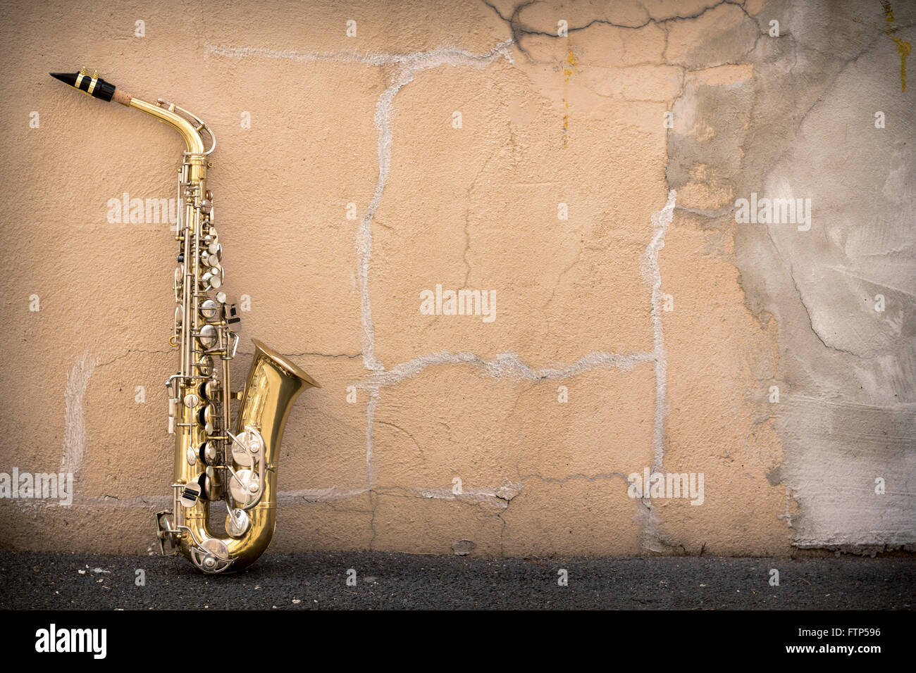Jazz musical instrument saxophone with grungy street background Stock Photo
