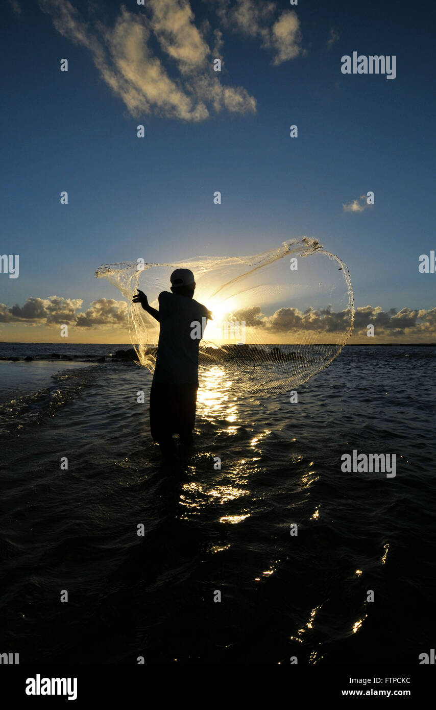 Fisherman casting his net at the sunrise or sunset. Traditional fishermen  prepare the fishing net 8355730 Stock Photo at Vecteezy