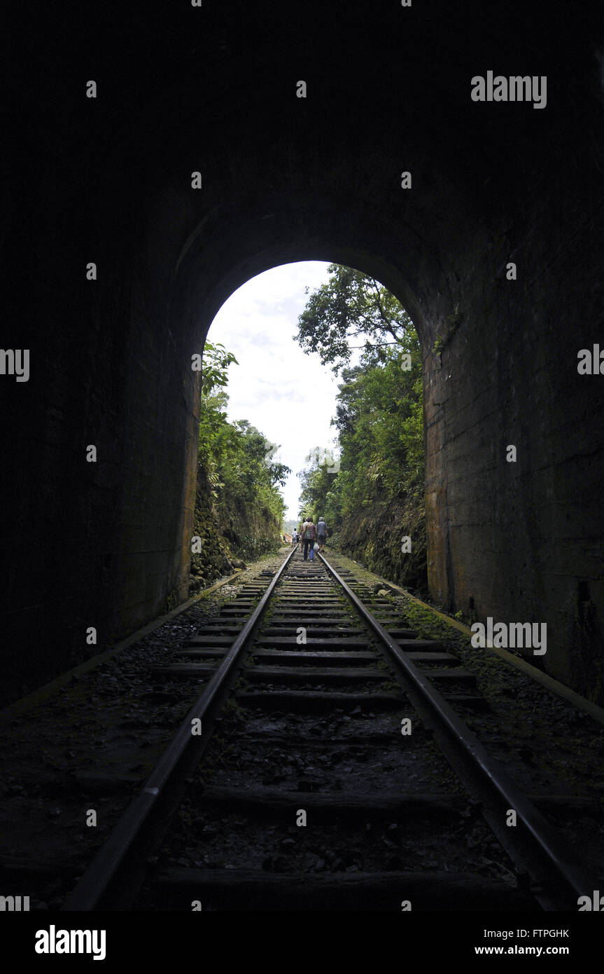 Tourists walking on the tracks of the tunnel near the railway Mantiqueira Colonel Fulgencio of ABPF Stock Photo